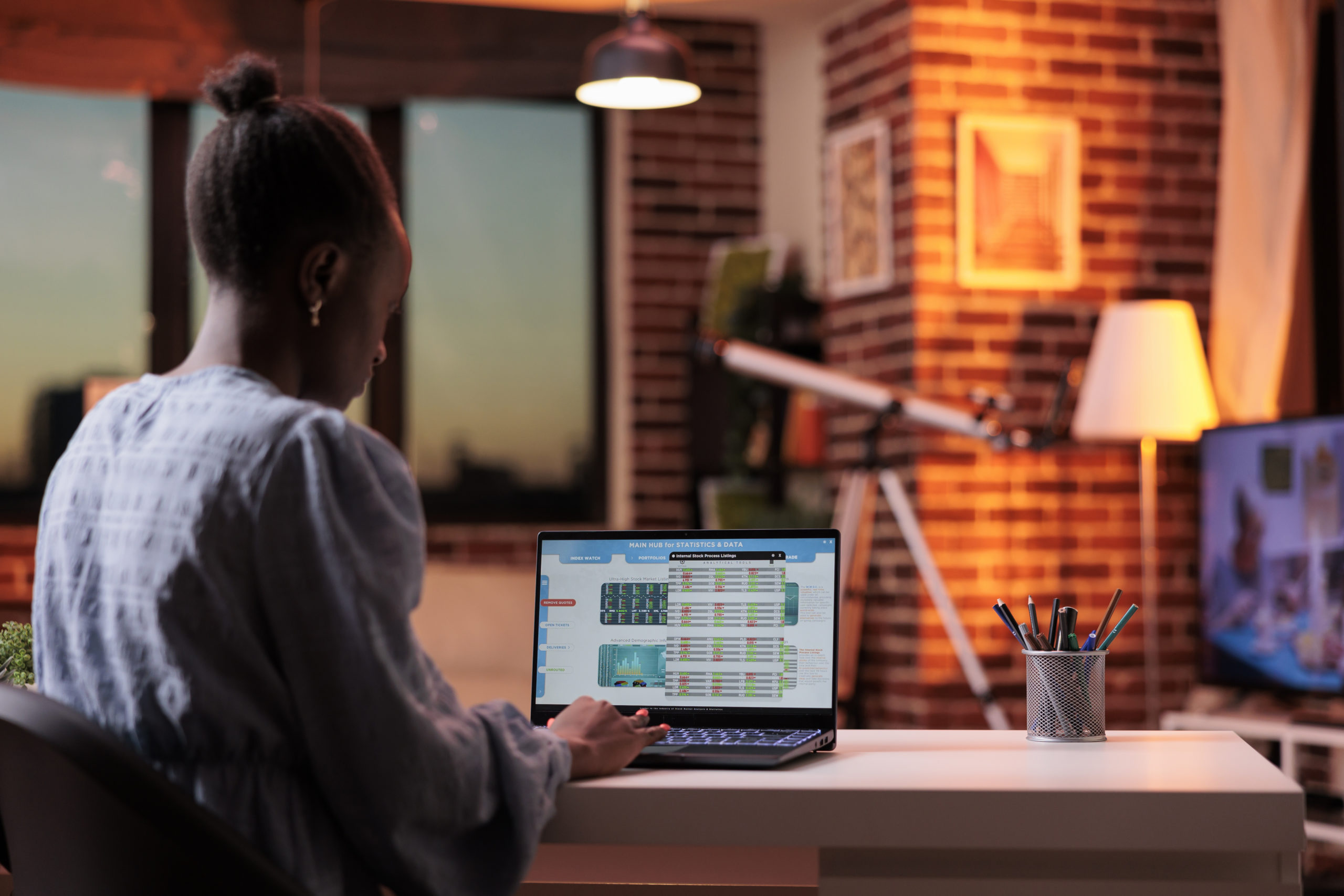 Company bookkeeper analyzing financial statistics on laptop screen